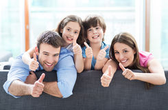 family-home-thumbs-up-happy-relaxing-sofa-54110677